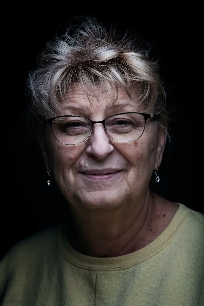 woman in green crew neck shirt wearing eyeglasses